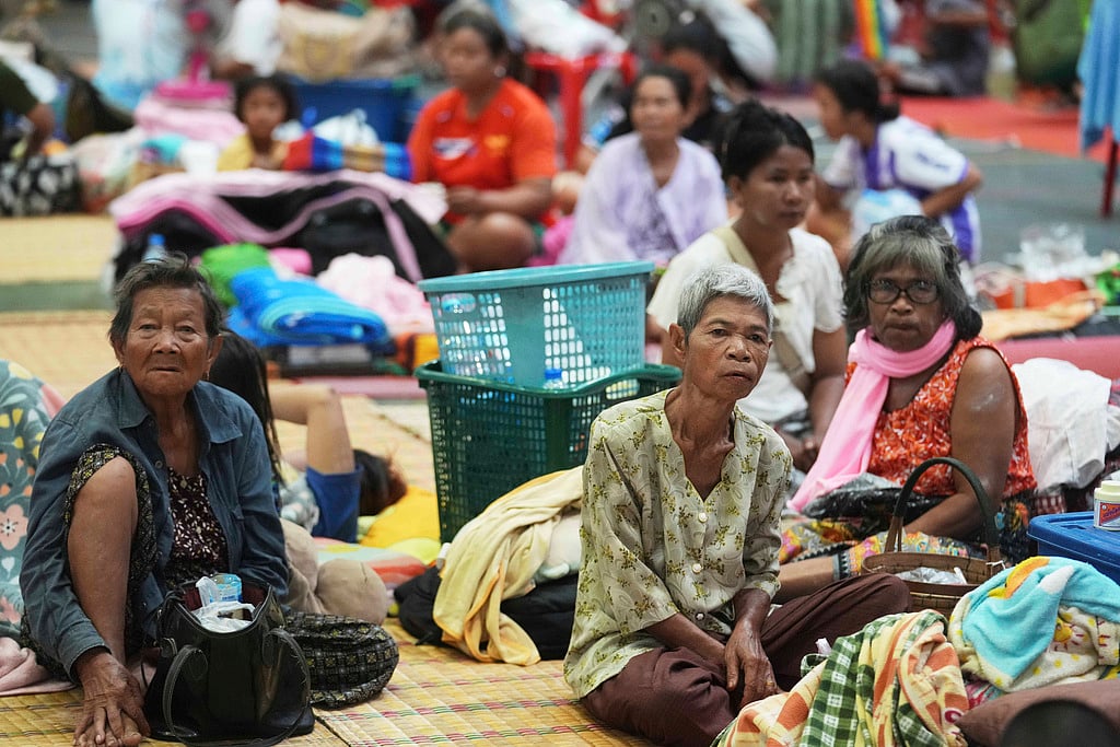 Thai residents who fled homes following clashes between Thai and Cambodian soldiers rest at an evacuation center in Surin province, Thailand, Friday. The border clash between Thailand and Cambodia has sparked a major humanitarian crisis. In just two days of fighting, more than 100,000 people have been forced to flee their homes. Families, including children and the elderly, are escaping in the night, seeking safety amid rising tension and violence.