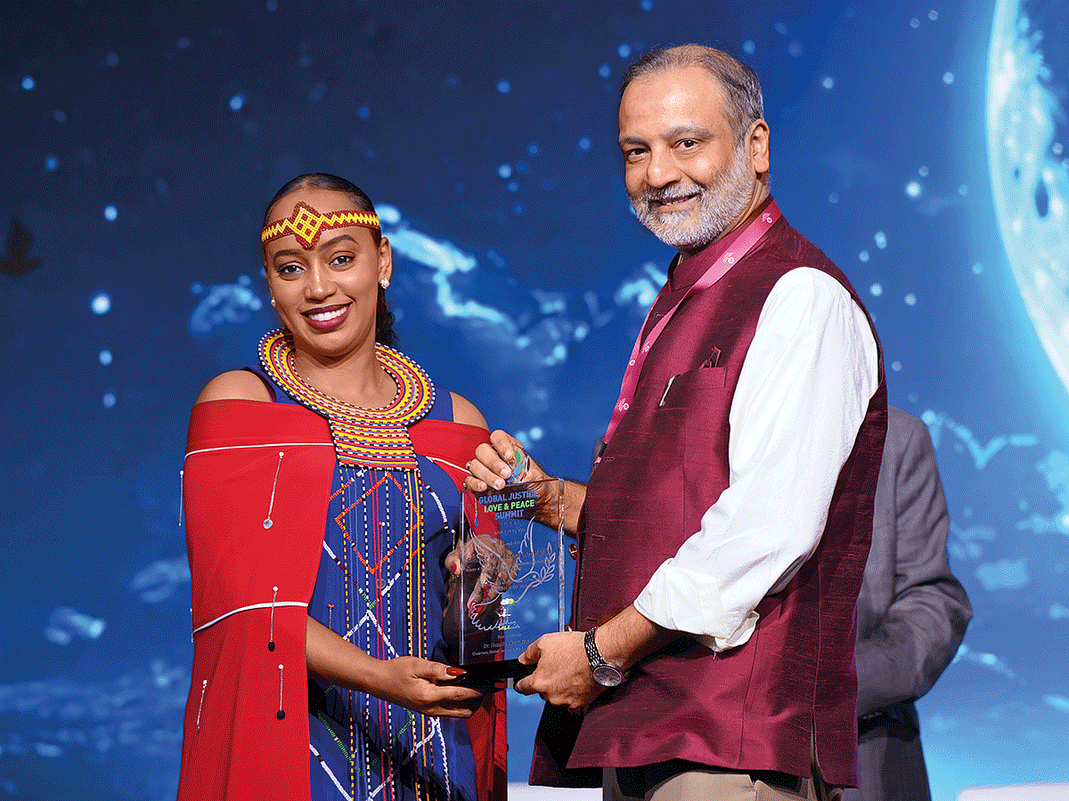 Hezena Lemaletian receiving a memento from Dr Huzaifa Khorakiwala, Chairman, World Peacekeepers Movement, and chief organiser of the Global Justice Love and Peace Summit in Dubai.
