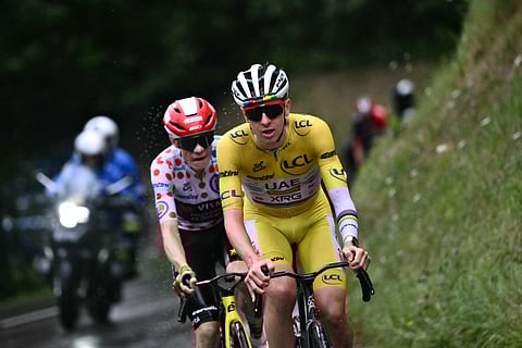 UAE Team Emirates' Tadej Pogacar wearing the overall leader's yellow jersey and Team Visma - Lease rider Jonas Vingegaard wearing the best climber's polka dot  jersey cycle in the final ascent on Friday.