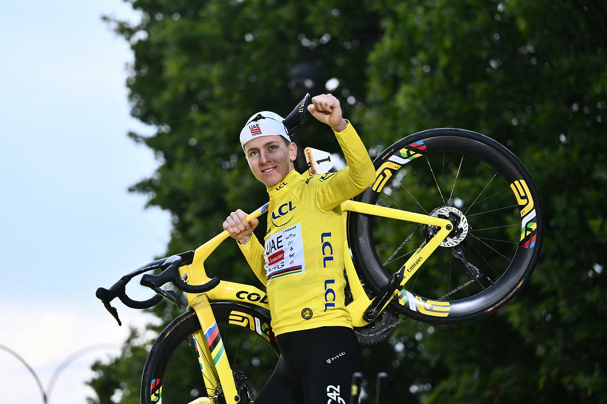 UAE Team Emirates - XRG team's Slovenian rider Tadej Pogacar celebrates on the podium with the overall leader's yellow jersey after the 21st and final stage of the 112th edition of the Tour de France cycling race, 132.3 km between Mantes-la-Ville and Paris Champs-Élysees, on July 27, 2025.