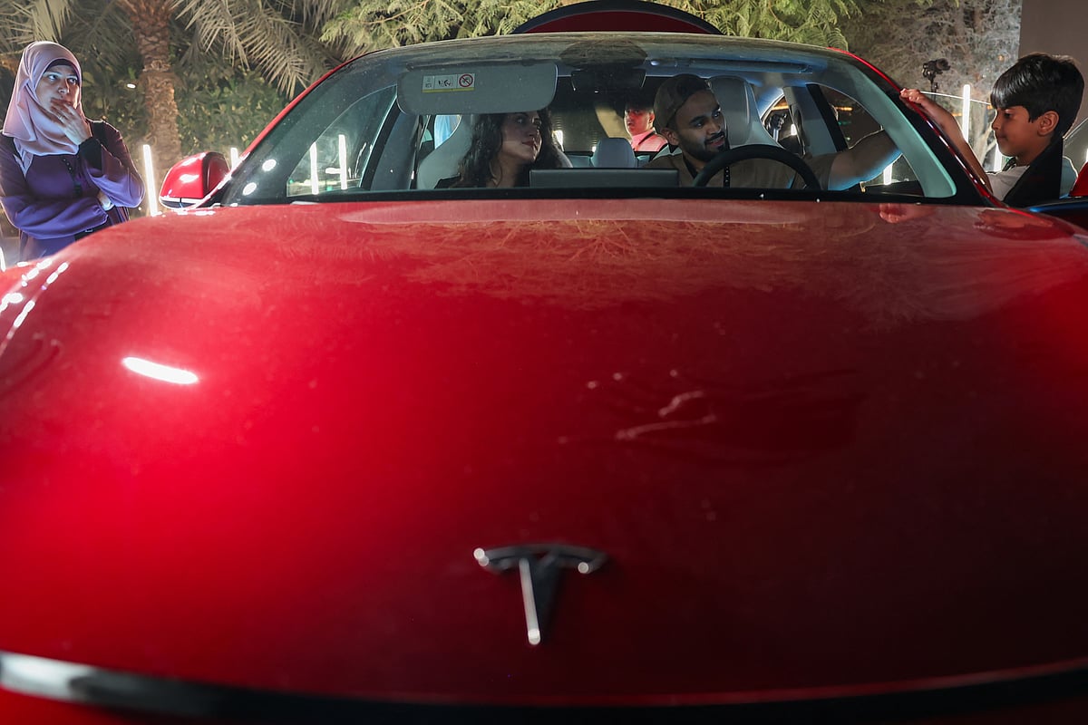 People check out a car on display during Tesla's official launch ceremony in Riyadh on April 10, 2025. The Tesla electric vehicle company owned by billionaire Elon Musk on April 10 opened its first showrooms in oil-rich Saudi Arabia, where hybrid cars are still not a common sight.