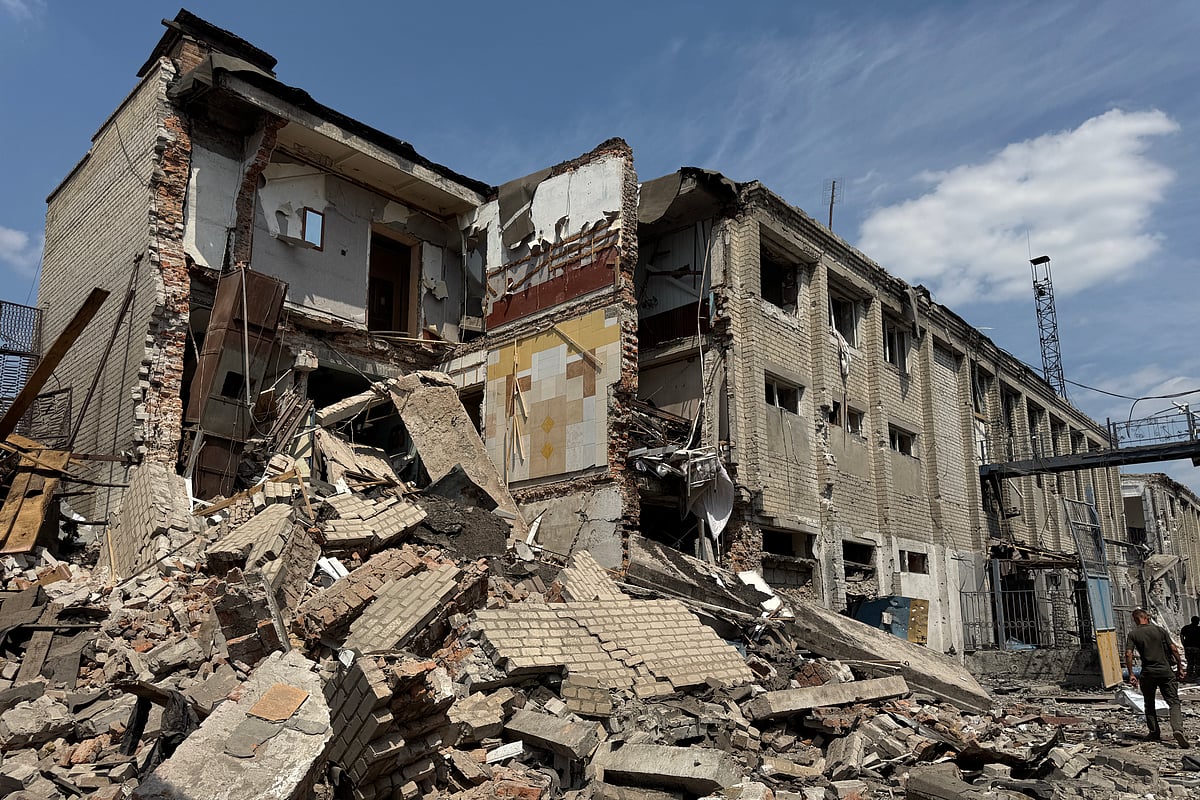A Ukrainian law enforcement officer walks past a destroyed building of the Bilenkivska correctional colony following an air attack in Bilenke, Zaporizhzhia region on July 29, 2025, amid the Russian invasion of Ukraine.