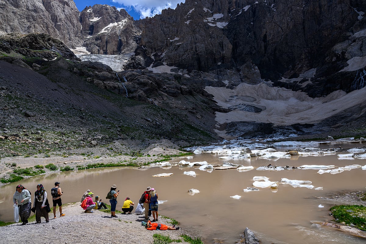 Hikers rest and take pictures on the Cilo Glaciers of Turkey's southeastern Hakkari province, on July 13, 2025.