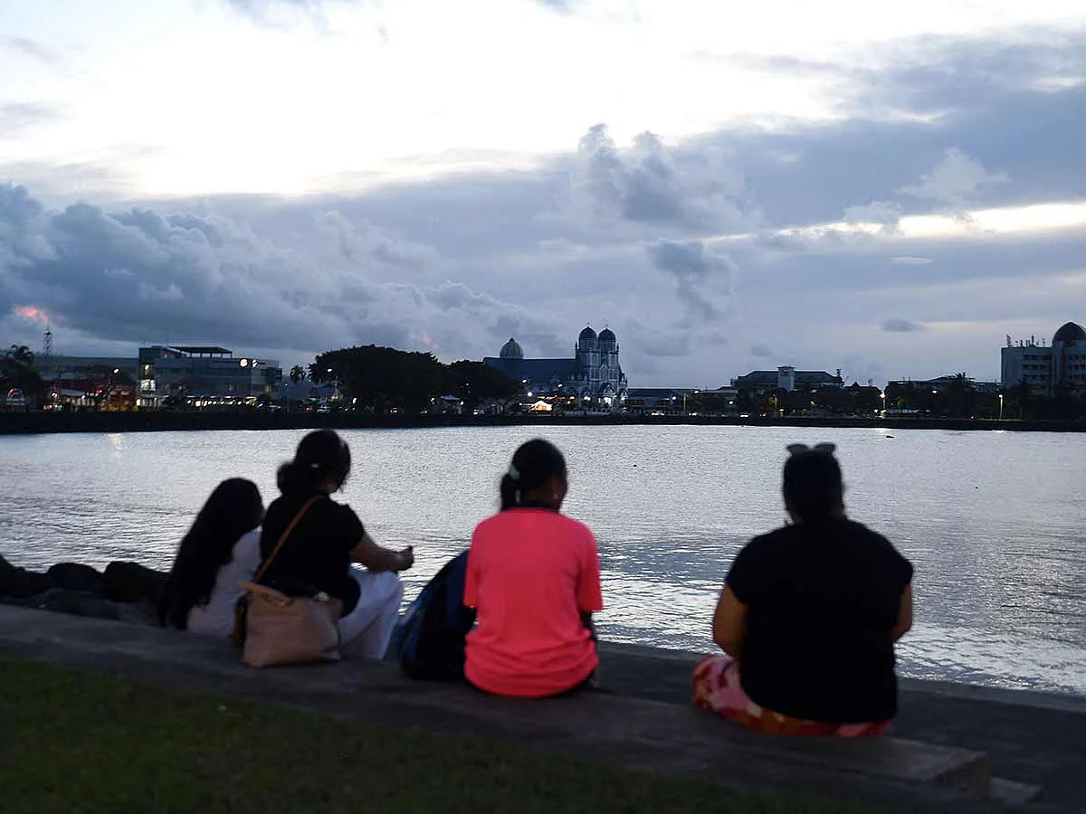 Residents watch the ocean in Samoa's capital city of Apia on July 30, 2025, as a tsunami warning is in effect.  