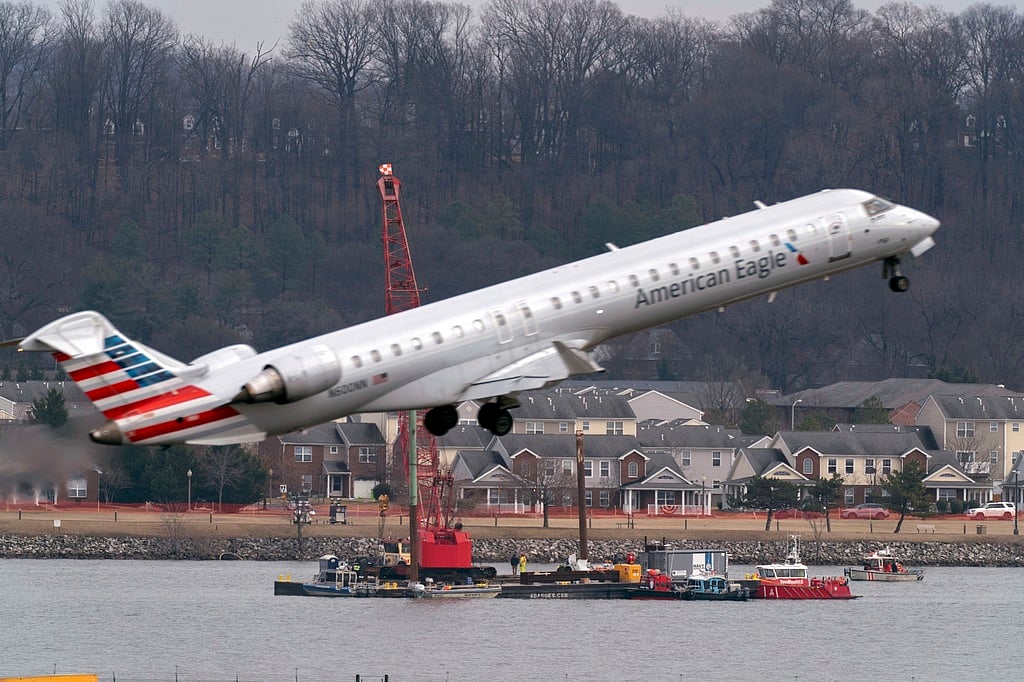 FILE - Salvage crews work on recovering wreckage near the site in the Potomac River of a mid-air collision between an American Airlines jet and a Black Hawk helicopter at Ronald Reagan Washington National Airport, Thursday, Feb. 6, 2025, in Arlington, Virginia.