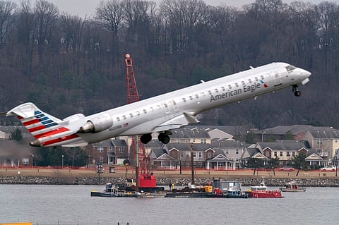 FILE - Salvage crews work on recovering wreckage near the site in the Potomac River of a mid-air collision between an American Airlines jet and a Black Hawk helicopter at Ronald Reagan Washington National Airport, Thursday, Feb. 6, 2025, in Arlington, Virginia.
