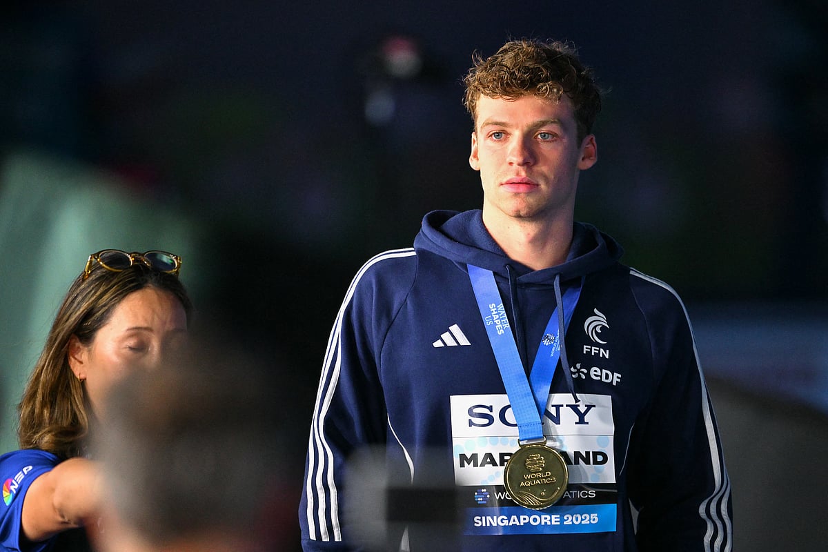 Gold medallist France's swimmer Leon Marchand celebrates on the podium of the men's 200m individual medley swimming event during the 2025 World Aquatics Championships in Singapore on July 31, 2025.