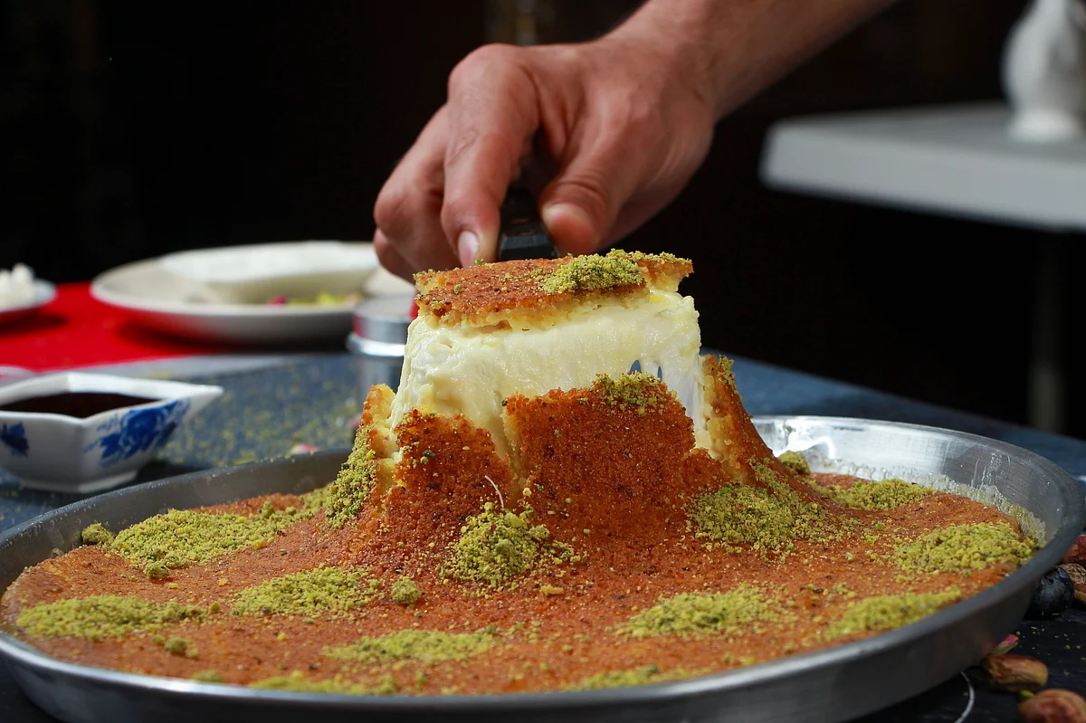 Kunafa is a rich Middle Eastern dessert made of delicate shredded pastry or semolina dough, layered with melted cheese or cream. 
