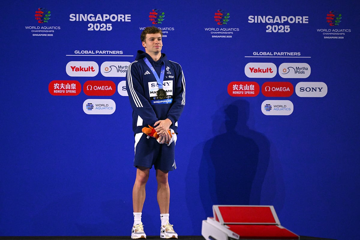 Gold medallist France's swimmer Leon Marchand celebrates on the podium of the men's 200m individual medley swimming event during the 2025 World Aquatics Championships in Singapore on July 31, 2025.