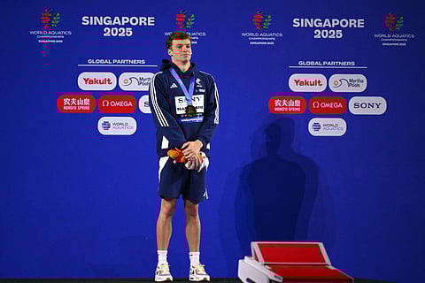 Gold medallist France's swimmer Leon Marchand celebrates on the podium of the men's 200m individual medley swimming event during the 2025 World Aquatics Championships in Singapore on July 31, 2025.