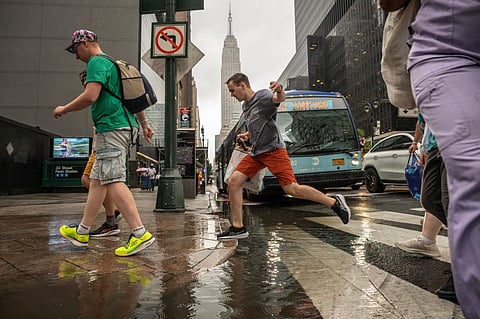 Pedestrians during a rainstorm in New York, US, on Thursday, July 31, 2025. New York City commuters are bracing for potential flooding from heavy rain Thursday, just hours after an unrelated power outage that continued to snarl subways late into the afternoon. 
