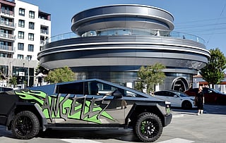 A Tesla Cybertruck drives outside the newly opened Tesla Diner on July 31, 2025 in Hollywood, California.