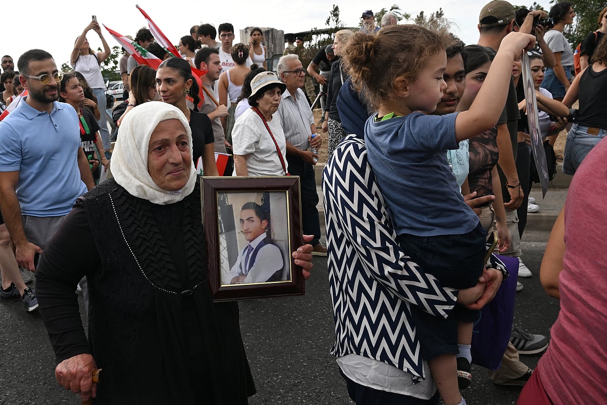 Lebanese demonstrators march during a gathering to honour the victims of the catastrophic port explosion in 2020 and to call for accountability for the blast, in Beirut on August 4, 2025.
