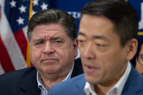 Illinois Governor JB Pritzker listens as Texas House Democratic Caucus Chair Gene Wu speaks to reporters following a press conference at the DuPage County Democratic Party headquarters on August 03, 2025 in Carol Stream, Illinois.