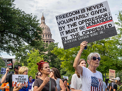 People protest against the recently introduced redistricting legislation during an emergency march and picket rally outside of the Governor's Mansion on August 04, 2025 in Austin, Texas.