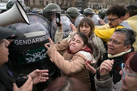 People with disabilities, their families, and healthcare workers clash with riot police during a protest against Argentine President Javier Milei's veto of a law that would have increased retirement and disability pensions in Buenos Aires on August 5, 2025.