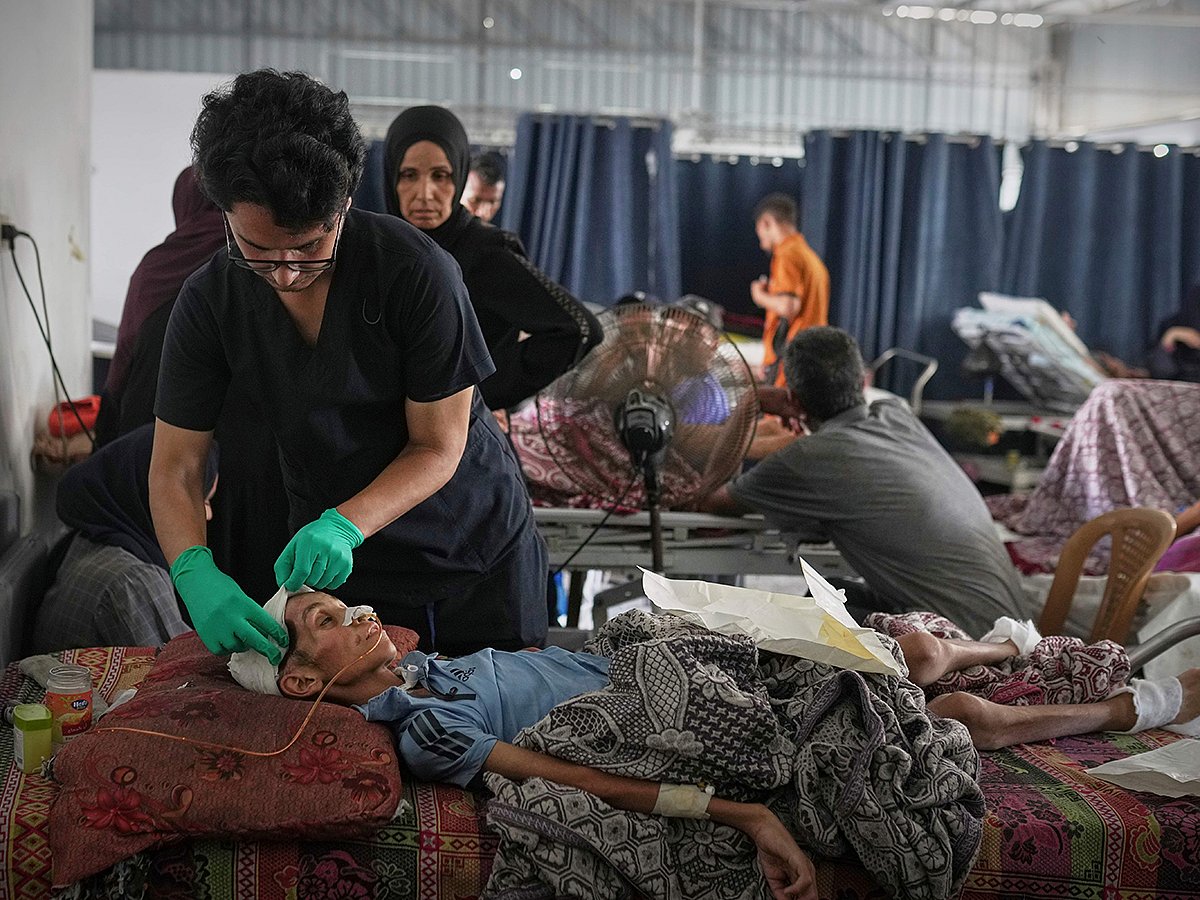 Dr Jamal Salha tends to a young patient at Shifa Hospital in Gaza City, July 7, 2025. 