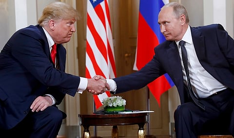President Donald Trump, left, and Russian President Vladimir Putin shake hands at the beginning of a meeting at the Presidential Palace in Helsinki, Finland, July 16, 2018. 