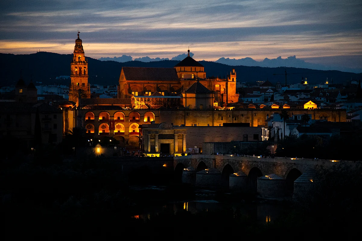 The Mosque-Cathedral of Cordoba is pictured next to the Roman bridge on June 11, 2023.