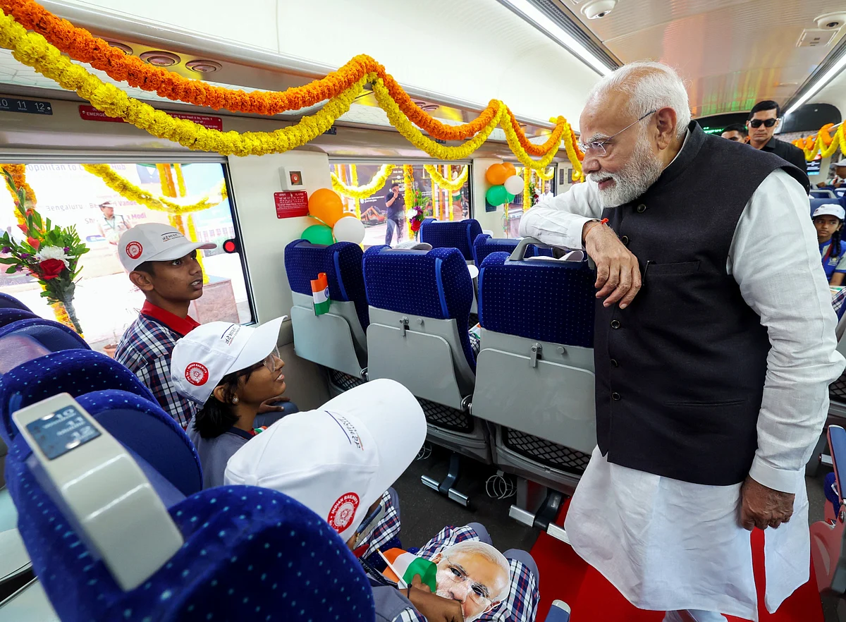 Modi interacts with children after flagging off 3 Vande Bharat Express trains, at KSR Railway Station in Bengaluru on Sunday.  