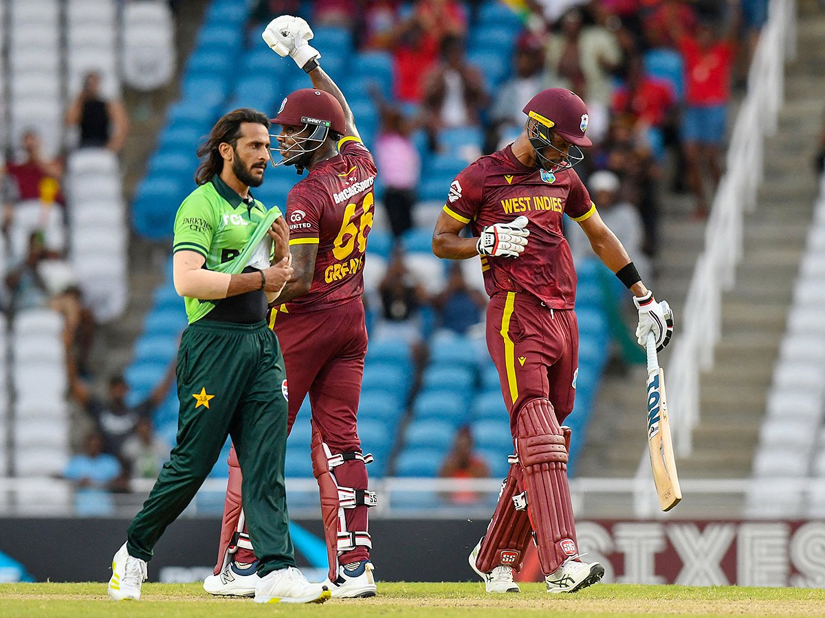 Hasan Ali (L) of Pakistan walks off the field while Justin Greaves (C) and Roston Chase (R) of West Indies celebrate winning the second ODI at Brian Lara Cricket Academy in Tarouba, San Fernando, Trinidad and Tobago on August 10, 2025.   