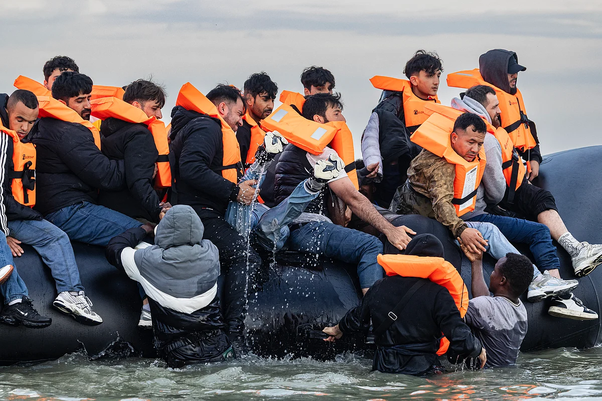 Migrants try to board a smuggler's boat in an attempt to cross the English Channel off the beach of Gravelines, northern France. In a dramatic scene unfolding at dawn on August 12, 2025, dozens of migrants sprinted across Gravelines beach in north of France in a desperate attempt to board a smuggler’s boat bound for the UK.
