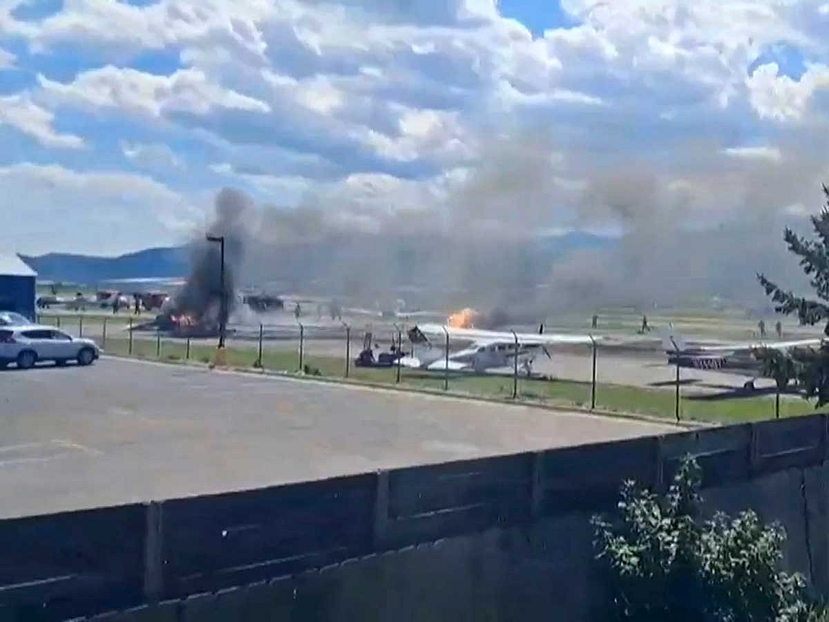A plane crashes into a parked aircraft at Kalispell City Airport, triggering a large fire, in Kalispell, Montana.