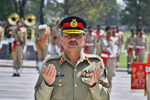 Pakistan Army Chief Field Marshal Asim Munir prays after laying wreath on the Martyrs monument during a special guard of honuor ceremony at General Headquarters, in Rawalpindi, Pakistan. File photo