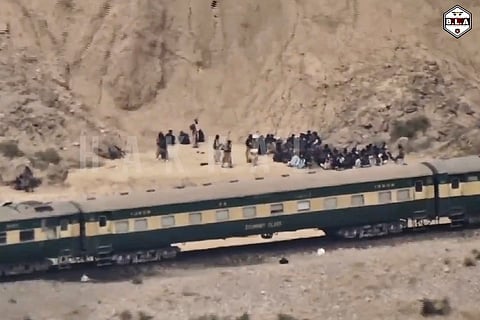 FILE -In this frame grab from a video released by the Baluchistan Liberation Army shows people outside the a train after being attacked by the BLA on its transit from Quetta to the northern city of Peshawar, in Bolan district, Pakistan's southwestern Balochistan province, March 12, 2025..(BLA via AP, File)
