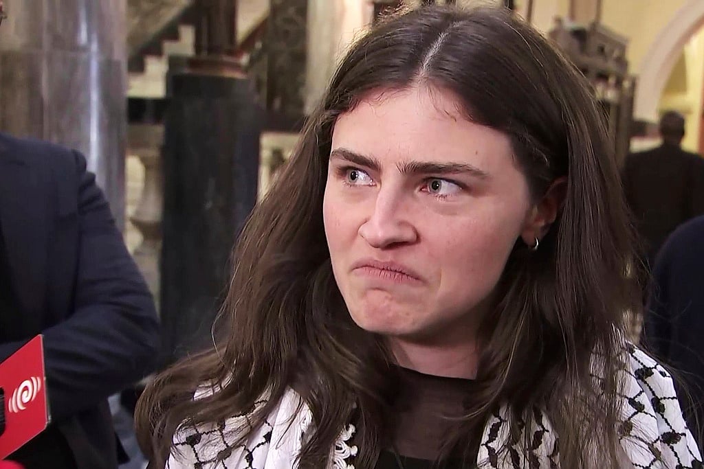 In this image made from video, New Zealand lawmaker Chlöe Swarbrick talks to the media after she was thrown out of Parliament, in Wellington, New Zealandon August 3, 2025.