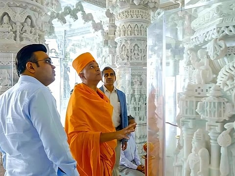 Pujya Brahmavihari Swami guides Jay Shah through the hand-carved marble interiors.