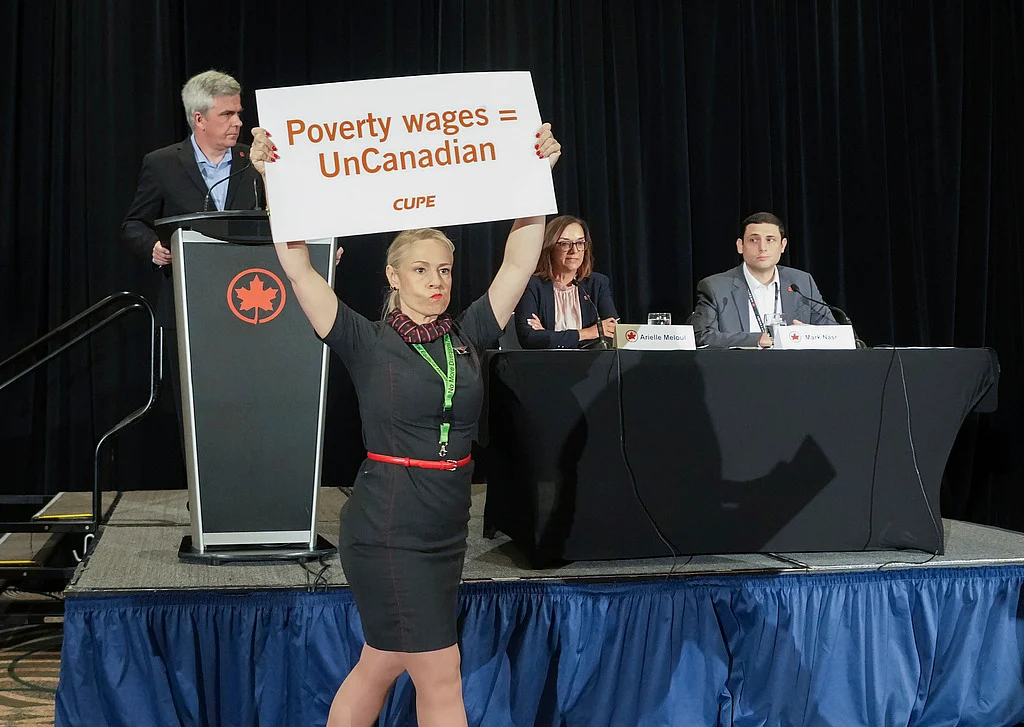 Air Canada executives are interrupted by Air Canada flight attendants during a news conference as a possible strike looms, in Toronto, on Thursday, Aug. 14, 2025.