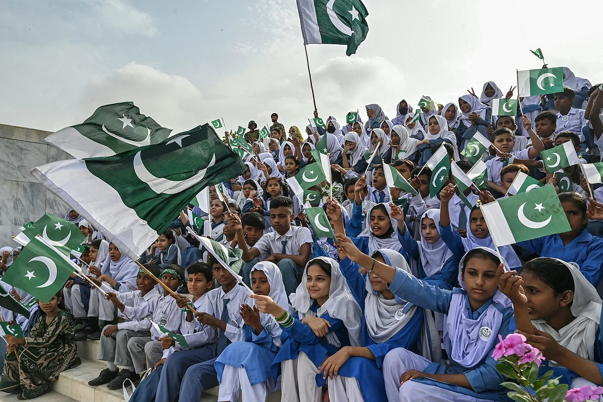Students wave Pakistan's national flags during Independence Day celebrations at the mausoleum of the country's founding father, Muhammad Ali Jinnah, in Karachi on August 14, 2025.