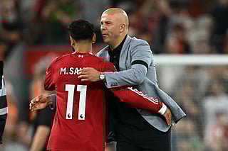Liverpool's Dutch manager Arne Slot embraces Liverpool's Egyptian striker #11 Mohamed Salah after the English Premier League football match between Liverpool and Bournemouth at Anfield in Liverpool, north west England on August 15, 2025.