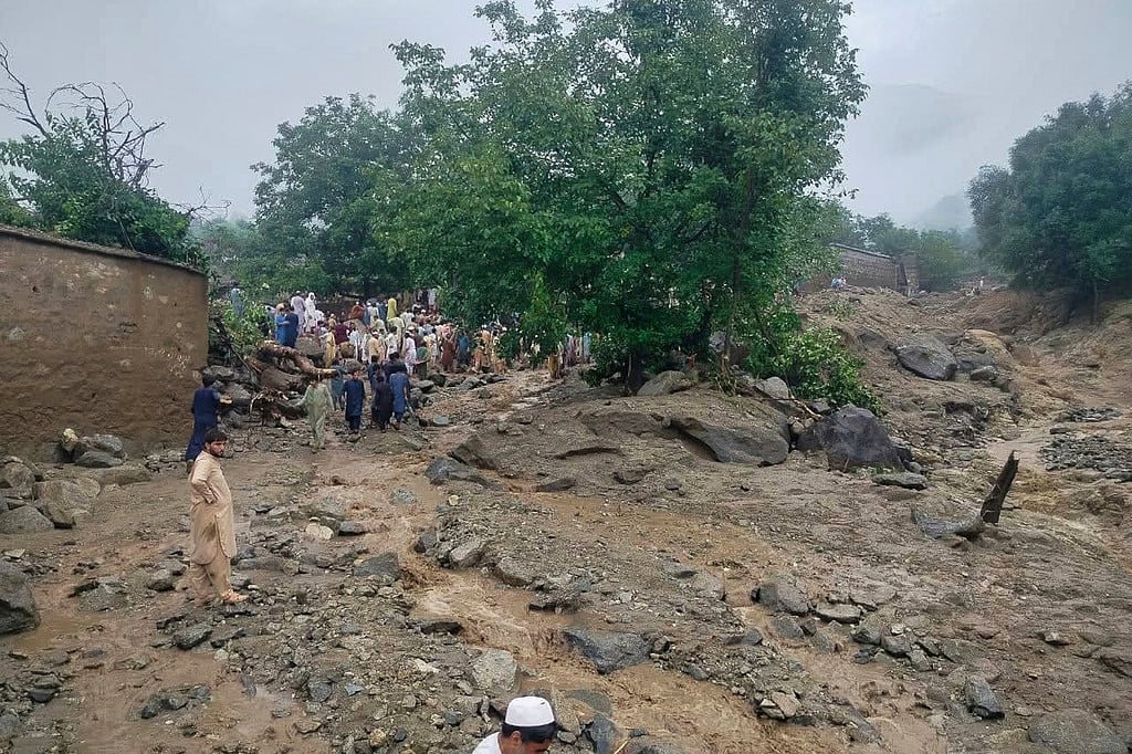 Rescue workers and local residents gather at the site of a massive cloudburst that led to flash flooding in Salarzai, Pakistan. (Rescue 1122 Emergency Department via AP)