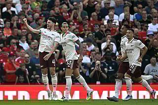 Arsenal's midfielder Declan Rice (L) and defender Riccardo Calafiori (2L) celebrate scoring the opening goalduring the English Premier League football match against Manchester United at Old Trafford in Manchester, north west England, on August 17, 2025.