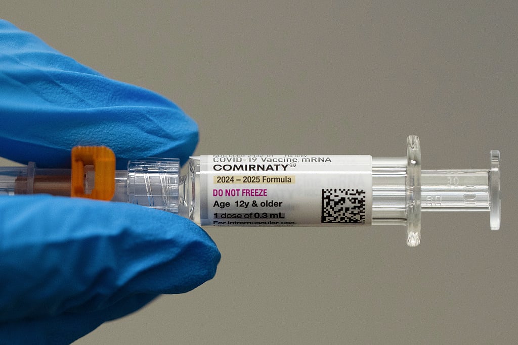 A pharmacist holds a Pfizer and BioNTech COVID-19 vaccine shot on Thursday, April 24, 2025, in Portland, Ore. 