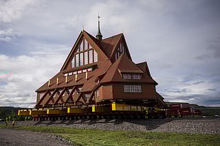 Workers use a remote controlled flatbed trailers with 224 wheels in total to move the wooden Kiruna Church, in Kiruna, Sweden on August 19, 2025.