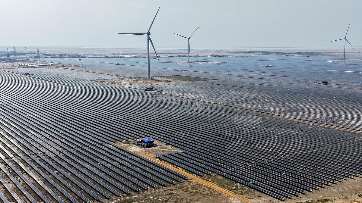 This aerial photograph taken on October 15, 2024, shows wind turbines and solar panels installed at the Adani Green Renewable Energy Plant in Khavda, in India's Gujarat state.