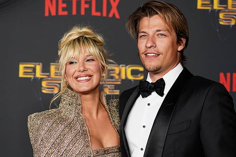 FILE - Millie Bobby Brown, left, and Jake Bongiovi arrive at the premiere of "The Electric State" on Monday, Feb. 24, 2025, at The Egyptian Theatre in Los Angeles. (Photo by Jordan Strauss/Invision/AP, File)