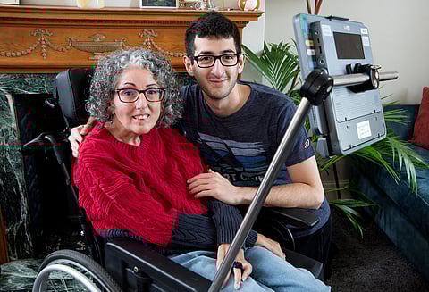 This handout image released by Smartbox Assistive Technology shows Sarah Ezekiel and her Son Eric at their home in Hendon, north London on August 16, 2025.