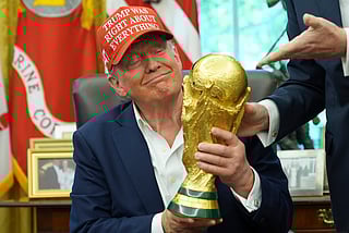 President Donald Trump holds the FIFA World Cup Winners Trophy during an announcement in the Oval Office of the White House, Friday, Aug. 22, 2025, in Washington. (AP Photo/Jacquelyn Martin)