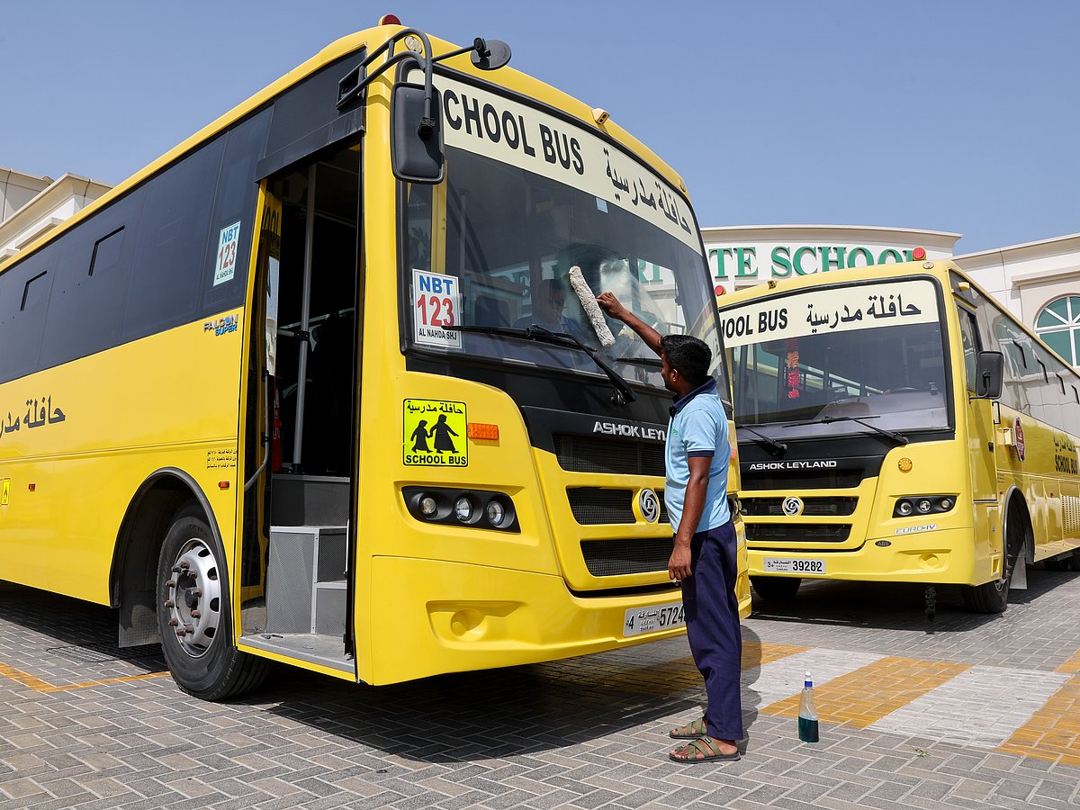 A worker cleans a school bus at Delhi Private School, Sharjah, ahead of UAE schools reopening Monday.