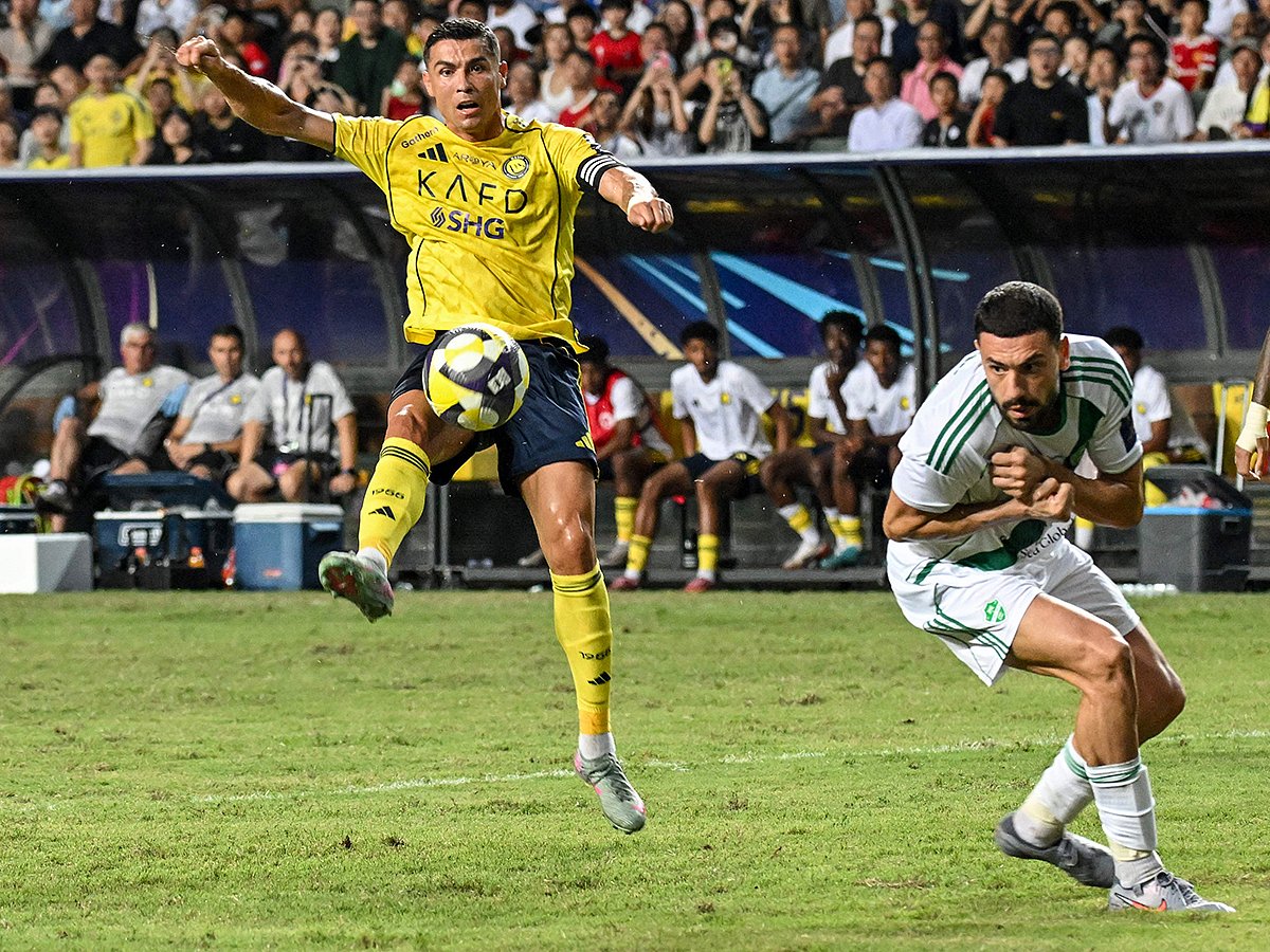 Al Nassr's Cristiano Ronaldo (L) vies for the ball during the Saudi Super Cup final football match against Al Ahli at the Hong Kong Stadium in Hong Kong on August 23, 2025. 