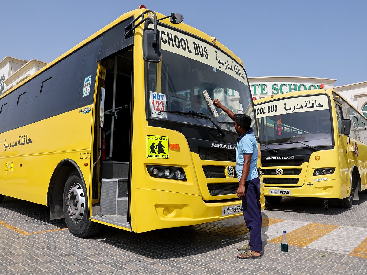 A worker cleans a school bus at Delhi Private School, Sharjah, ahead of UAE schools reopening Monday.