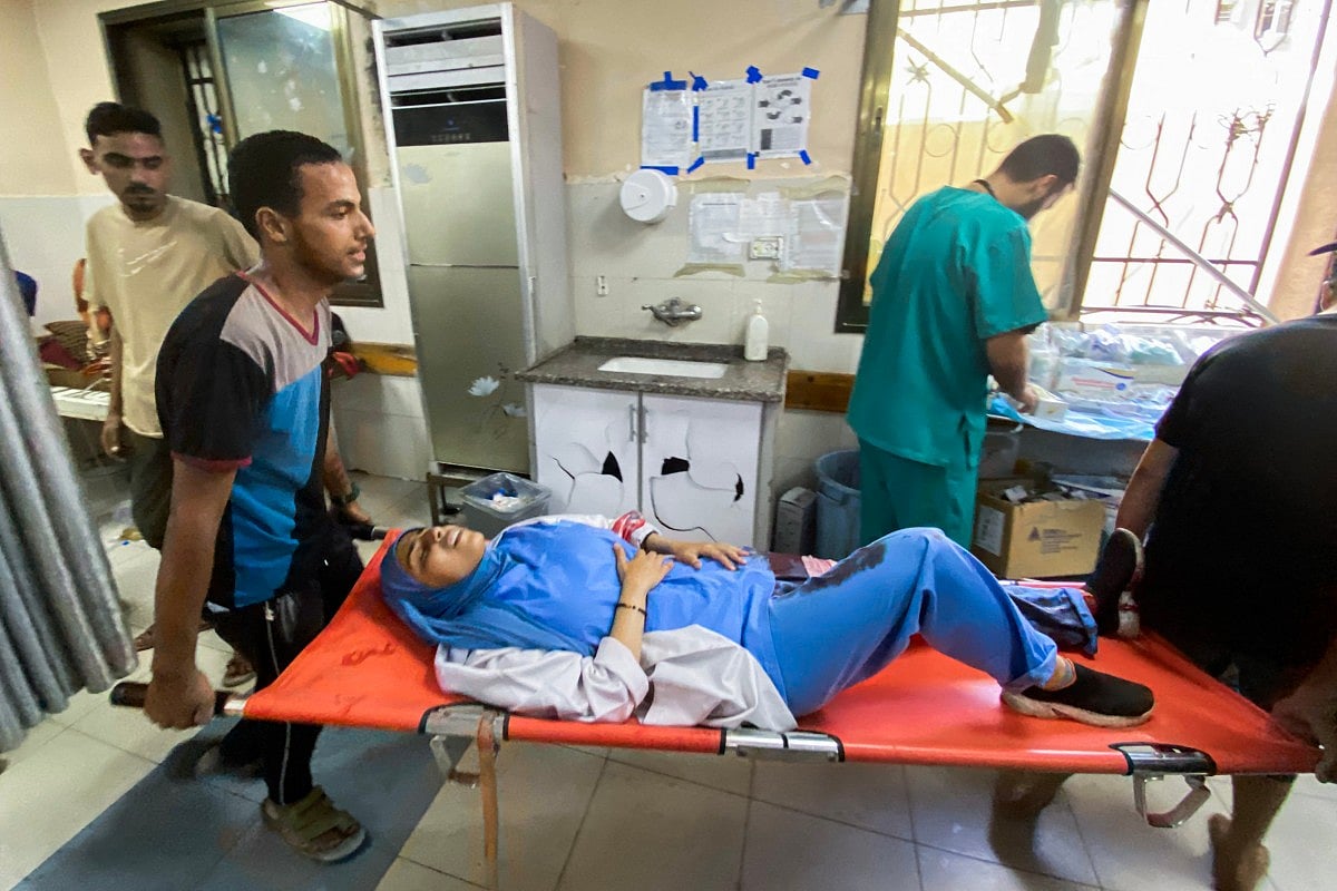 A medic injured in Israeli strikes on Nasser hospital in Khan Yunis in the southern Gaza Strip on August 25, 2025.