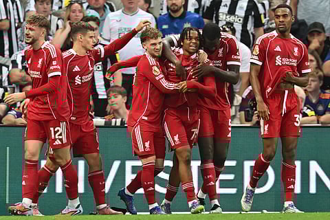 Liverpool's English strikerRio Ngumoha (C) celebrates with teammates after scoring their third goal during the English Premier League football match against Newcastle United at St James' Park in Newcastle-upon-Tyne, north east England on August 25, 2025.