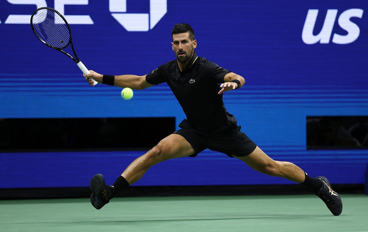 Novak Djokovic of Serbia plays a forehand against Learner Tien of the United States during their Men's Singles First Round match on Day One of the 2025 US Open at USTA Billie Jean King National Tennis Center on August 24, 2025 in the Flushing neighborhood of the Queens borough of New York City.