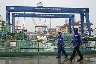 Workers walk around the construction site of the Metro Manila Subway Project (MMSP) during an inspection in Quezon City, Metro Manila on August 28, 2025.