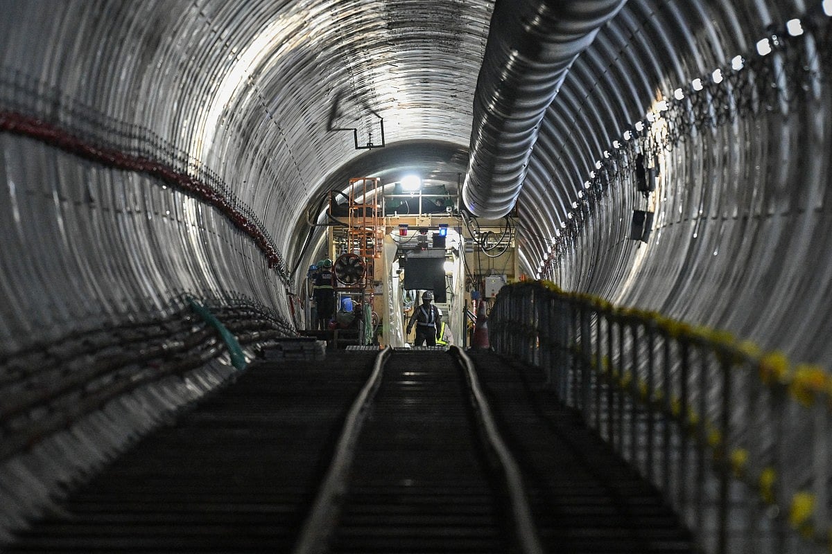 Workers walk along a tunnel of the under-construction Metro Manila Subway Project (MMSP) during an inspection in Quezon City. File photo taken on August 28, 2025.